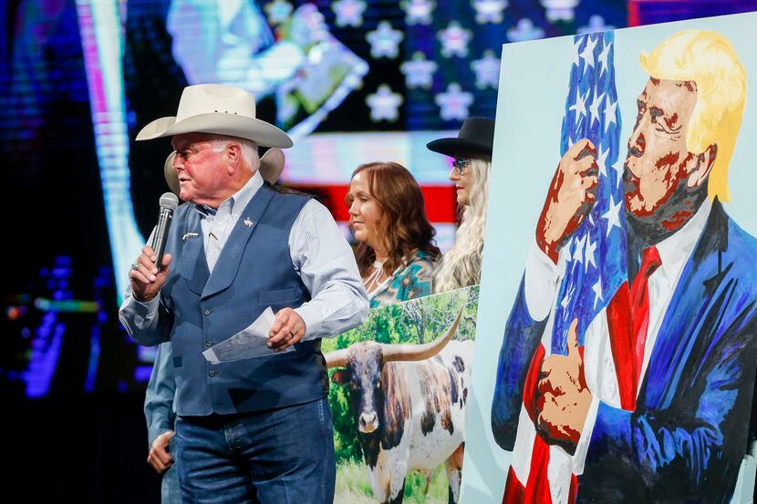 Texas Agriculture Commissioner Sid Miller calls an auction for a painting of former...