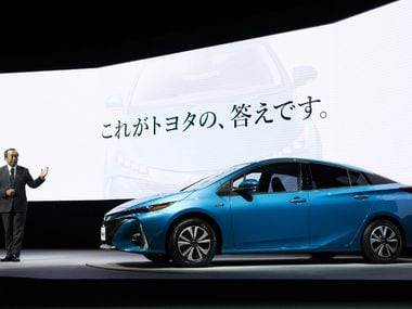 Takeshi Uchiyamada, chairman of Toyota Motor Corp., introduces the company's new Prius...