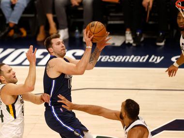 Dallas Mavericks guard Luka Doncic (77) attempts a shot in between Utah Jazz forward Bojan...