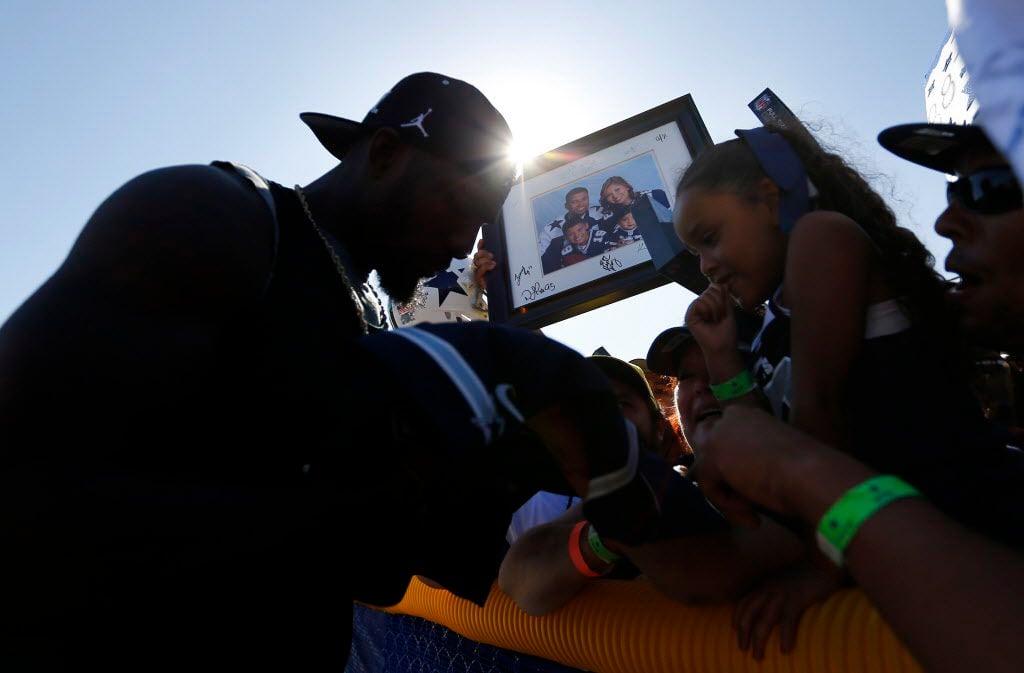 Dallas Cowboys wide receiver Dez Bryant signs autographs for fans following  the Blue-White...