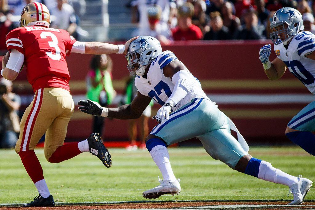 San Francisco 49ers quarterback C.J. Beathard (3) gets past Dallas Cowboys defensive end...