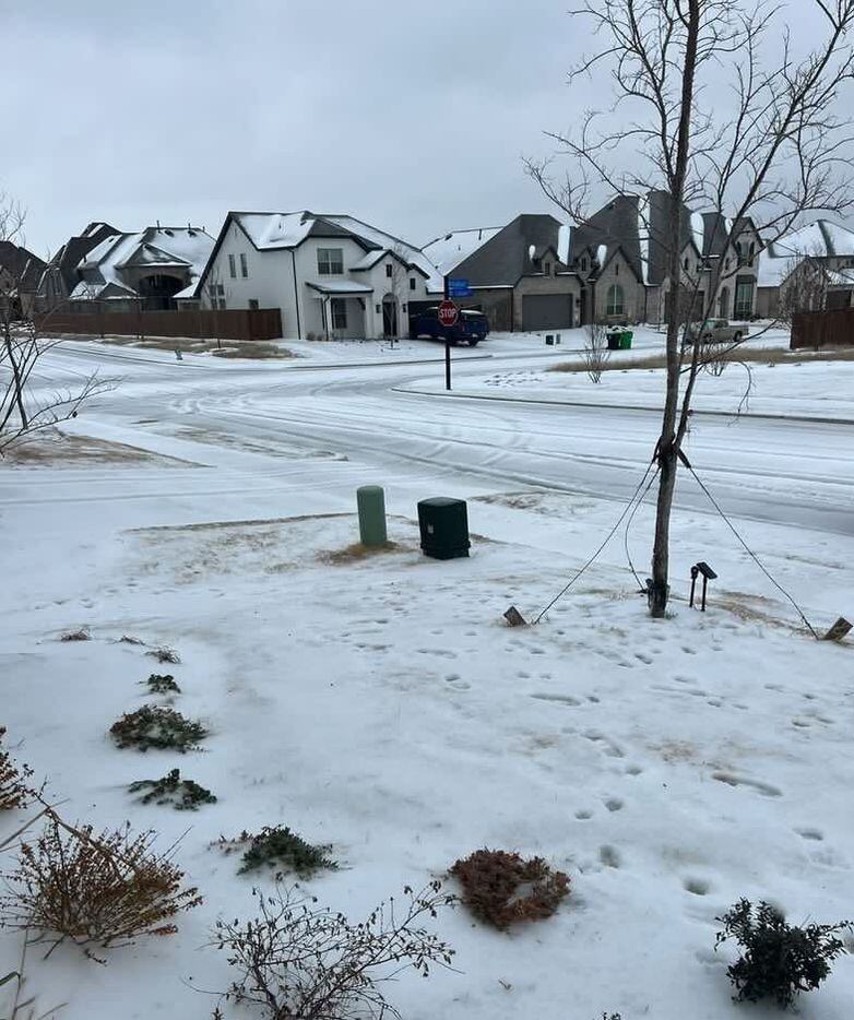 Snow and ice cover homes in Aubrey, Texas.