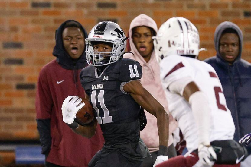 Arlington Martin wide receiver Jeremiah Charles (11) races down the sideline ahead of...