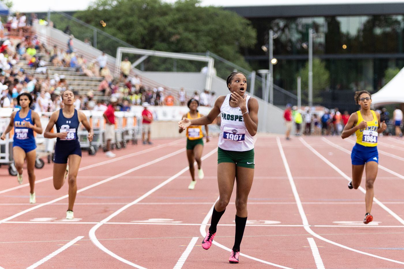 Lauren Lewis of Prosper reacts to winning the girls’ 400-meter dash at the UIL Track & Field...