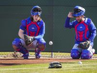 Texas Rangers catchers Jonah Heim (left) and Jose Trevino wait their turn in a defensive...