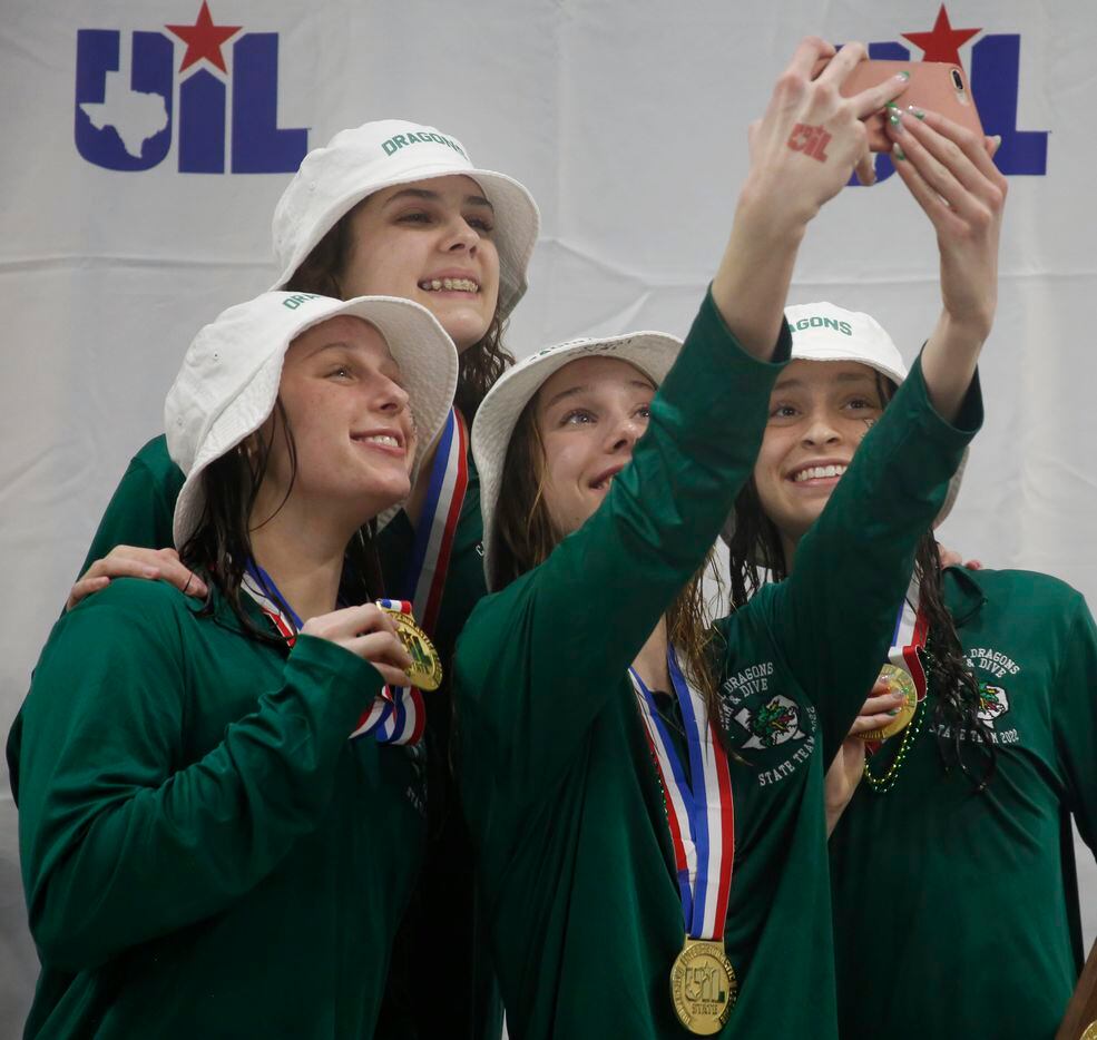 Members of the Southlake Carroll Girls Swim team pose for a selfie after getting their first...
