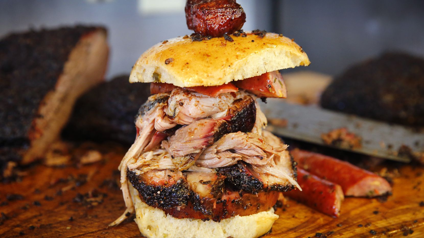 Panther City BBQ co-pitmasters Ernie Morales and Chris Magallanes prepared a Southside Slammer sandwich comprised of (from bottom) smoked bologna, brisket, pulled pork, jalape–o cheese sausage and topped with pork belly.