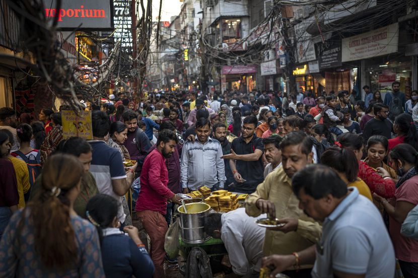 Gente toma comida callejera en un mercado abarrotado en Nueva Delhi, India, el sábado 12 de...
