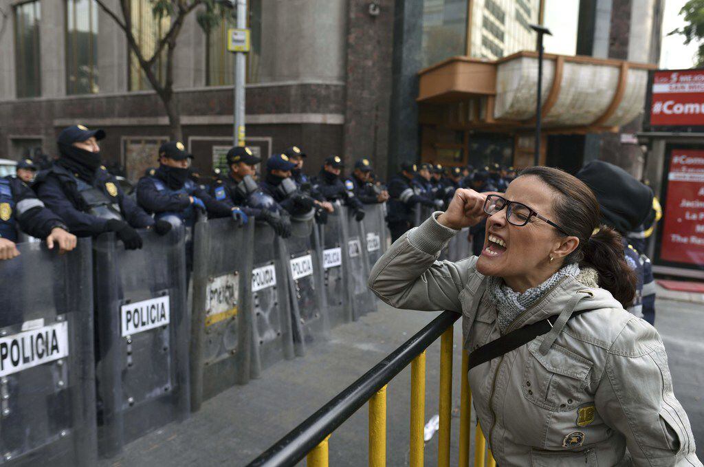 A demonstrator shouts slogans in front of the Senate building in Mexico City during a Dec....