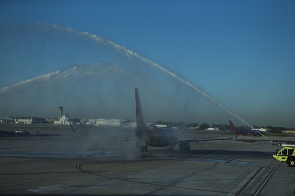 A Southwest Airlines flight to Cancun passes under streams of water as a celebratory gesture...