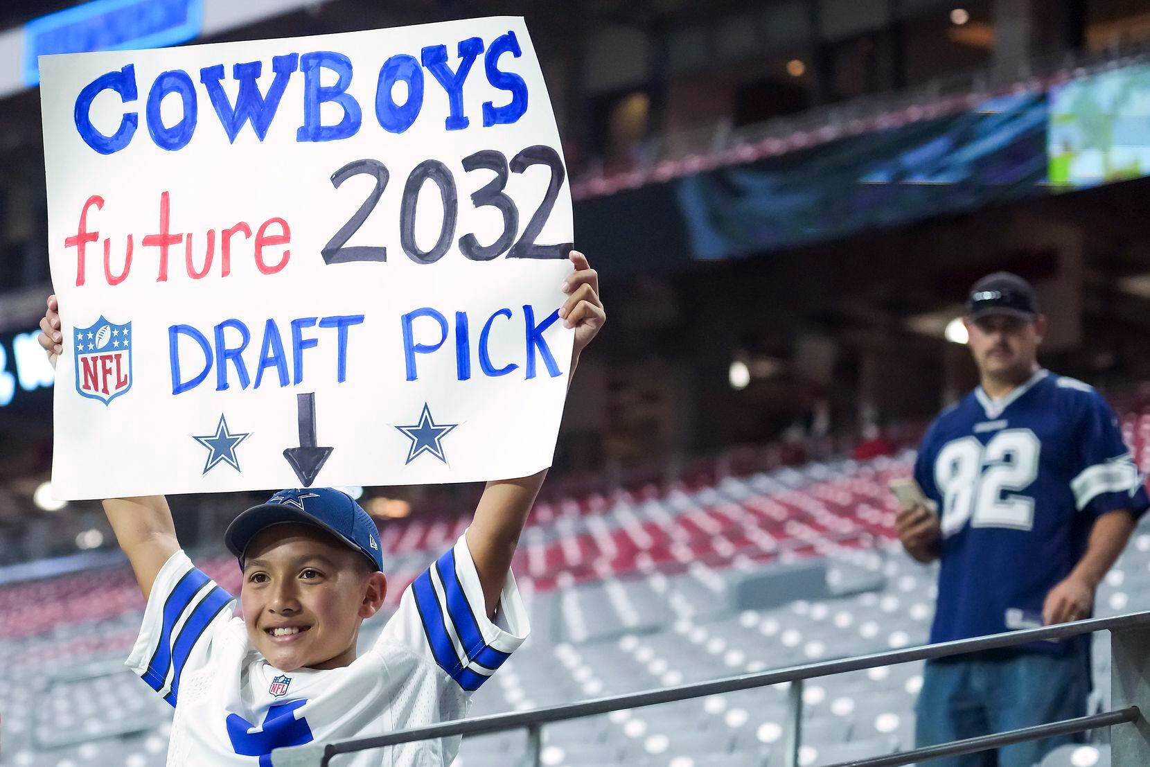 Eleven-year-old Cowboys fan Marcus Serrano held up a sign before a preseason game Aug. 13, 2021.