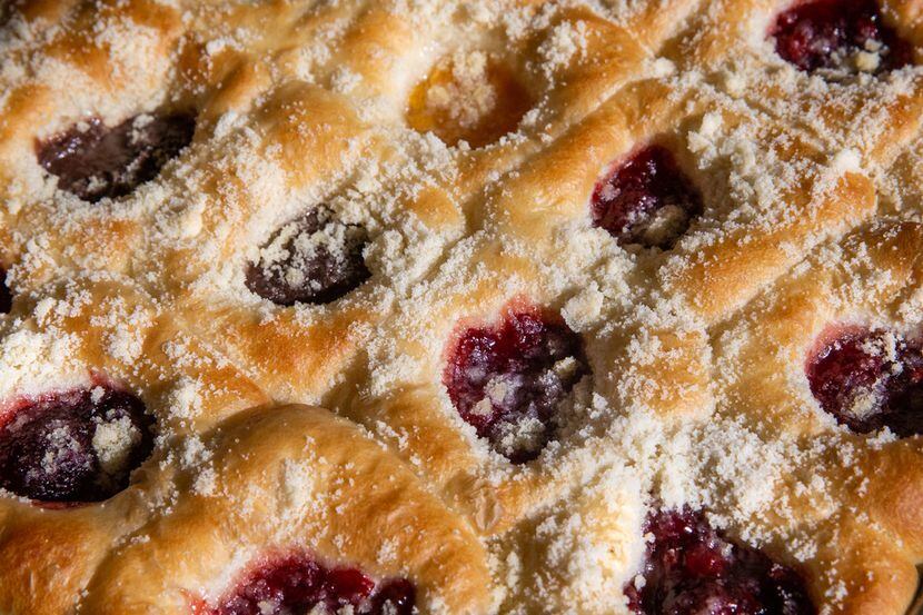 A pan of assorted kolache flavors is photographed in the Kasa Kolache bakery located in...