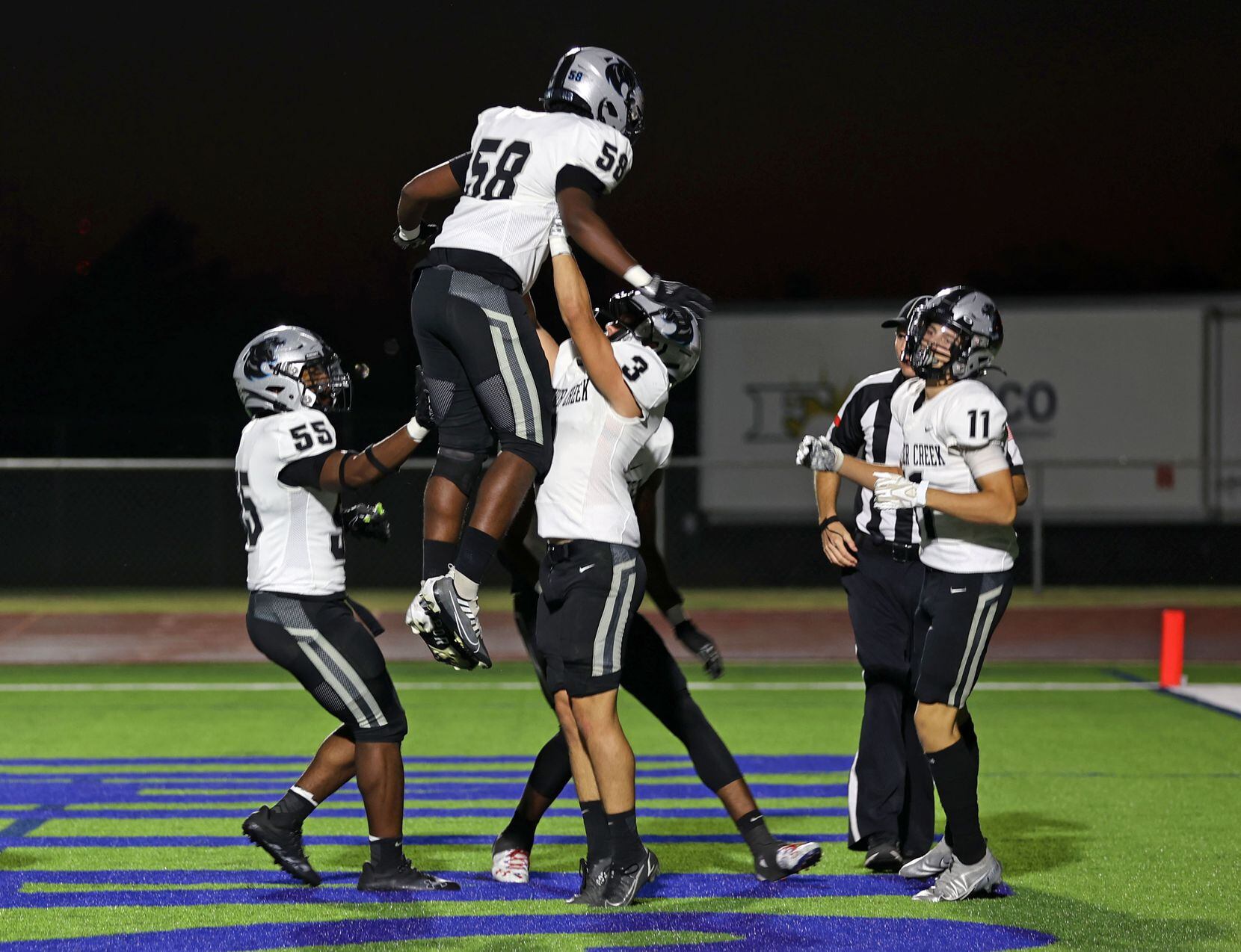 Frisco Panther Creek teammates celebrate after a touchdown by teammate Cristian Trickett...