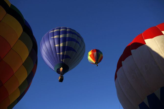 Hot air balloons take off during a balloon festival at Oak Point Park in Plano, Sunday,...