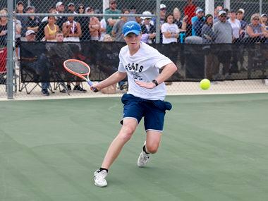 Highland Park’s Carl Newell runs to hit a return during the 5A boys doubles championship...