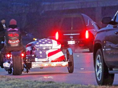 A motorcycle carrying Richardson police officer David Sherrard leads funeral procession at...