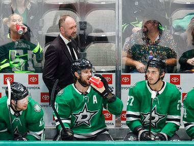 Dallas Stars head coach Peter DeBoer walks the bench during the first period of an NHL game...
