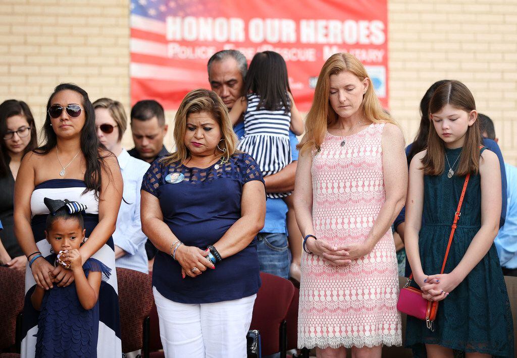 The families of fallen Dallas police officers Patrick Zamarripa and Michael Smith stand...