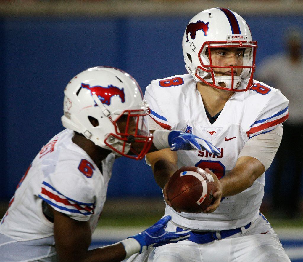Southern Methodist Mustangs quarterback Ben Hicks (8) hands the ball off to running back Braeden West (6) ) against Liberty Flames at Gerald J. Ford Stadium in Dallas, Texas on Saturday Sept. 17, 2016.  (Nathan Hunsinger/The Dallas Morning News)