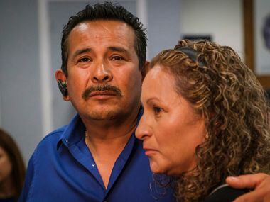 Rogelio Santander hugs his wife Julia Santander during a ceremony at the Dallas Police...