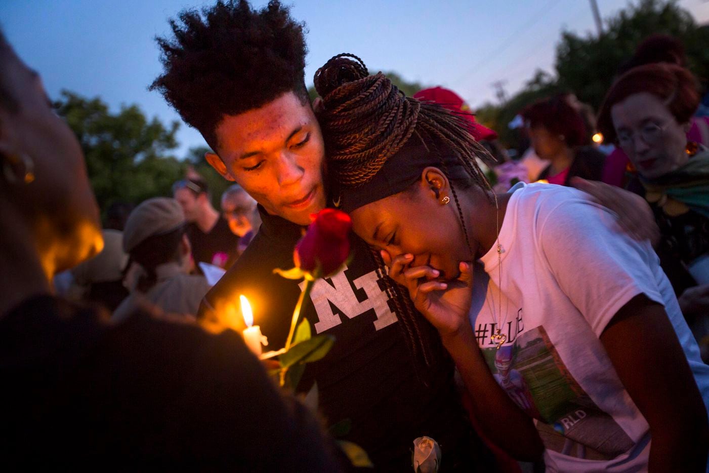Ashuntae Coleman, 14, is consoled by De'Juan Johnson, 15, during the "Remember His Name:...