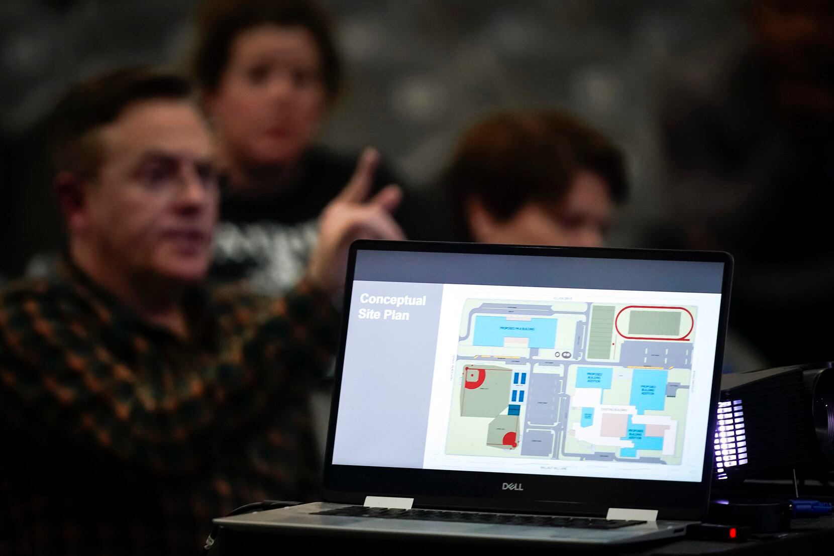 A presentation is seen on a laptop during a community meeting about the future of...