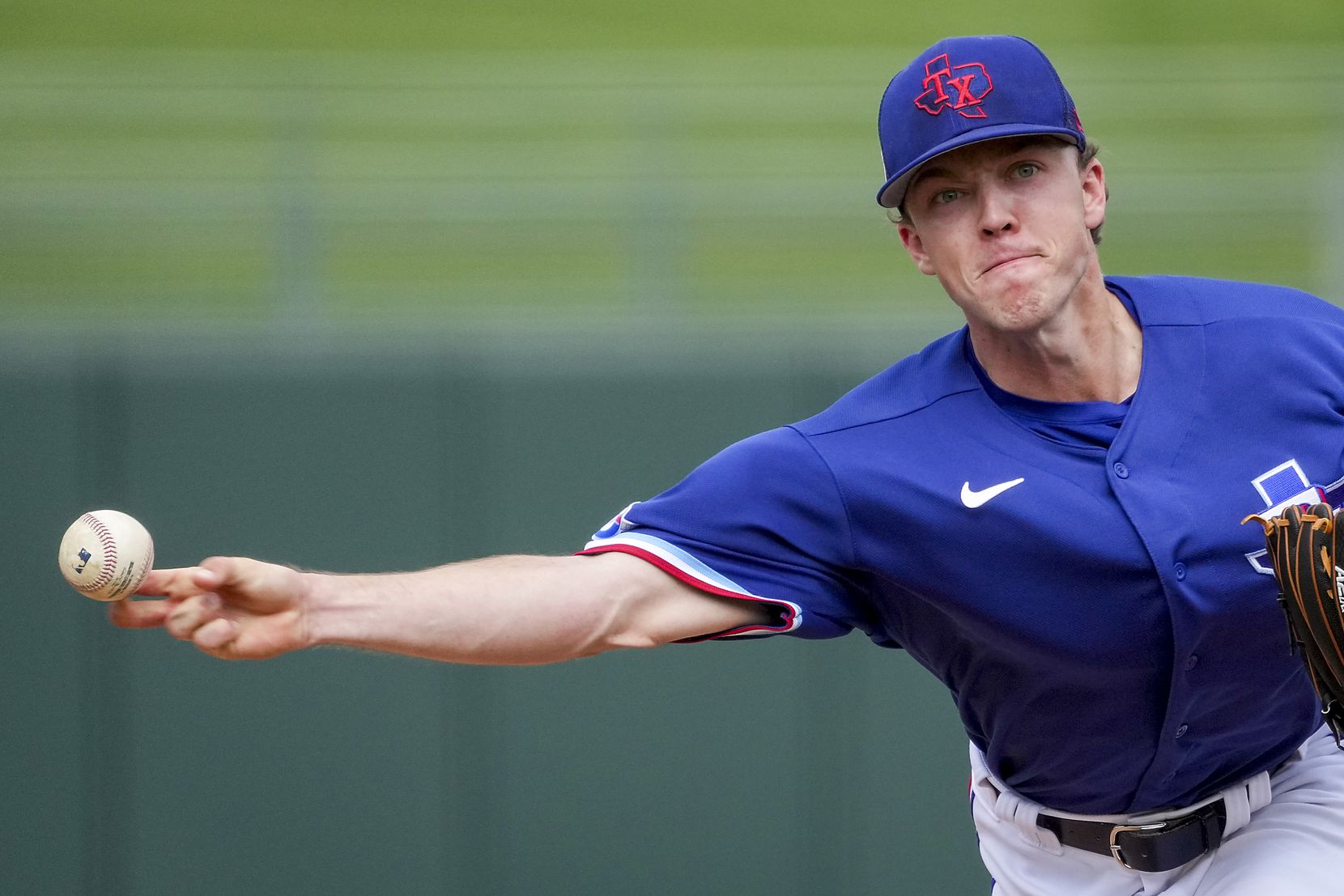 Texas Rangers pitcher Chase Lee delivers during the seventh inning of a spring training game...