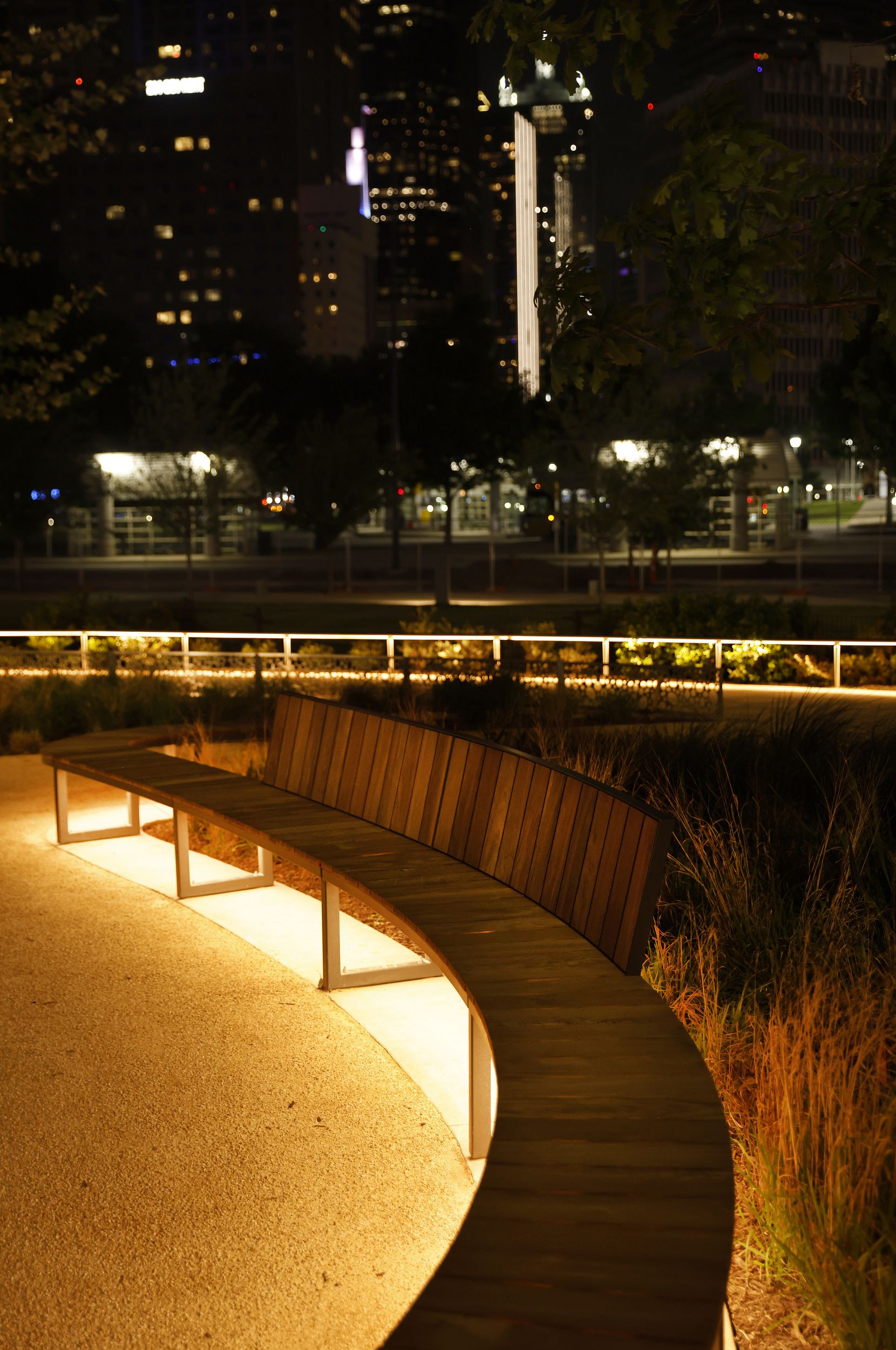 Lights under benches and low rails light up the newly constructed Carpenter Park at night,...