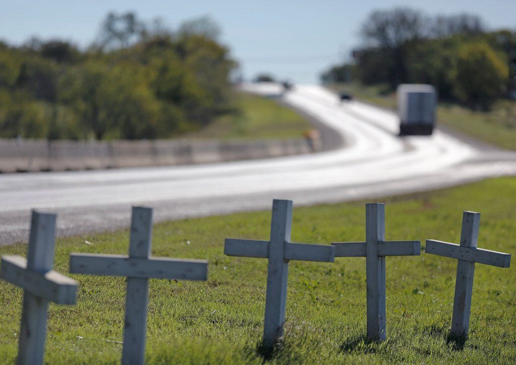 A row of crosses sit on the shoulder off of Highway 87 just north of the city limits in...