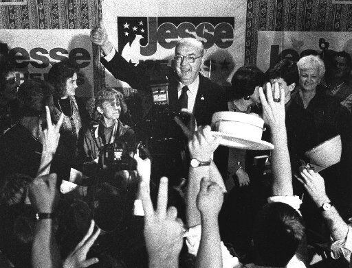 Sen. Jesse Helms, R-N.C., gives the thumbs-up to his supporters at the Brownstone Hotel...