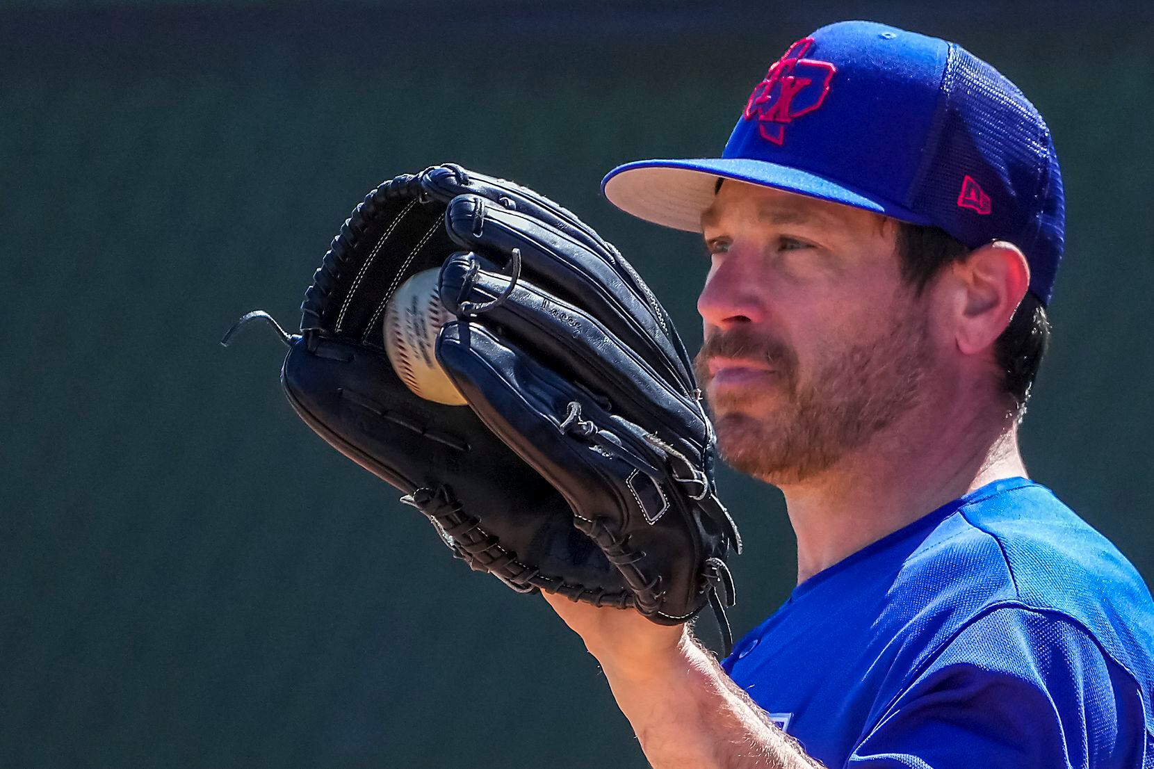 Texas Rangers pitcher Greg Holland works in the bullpen during a spring training workout at...