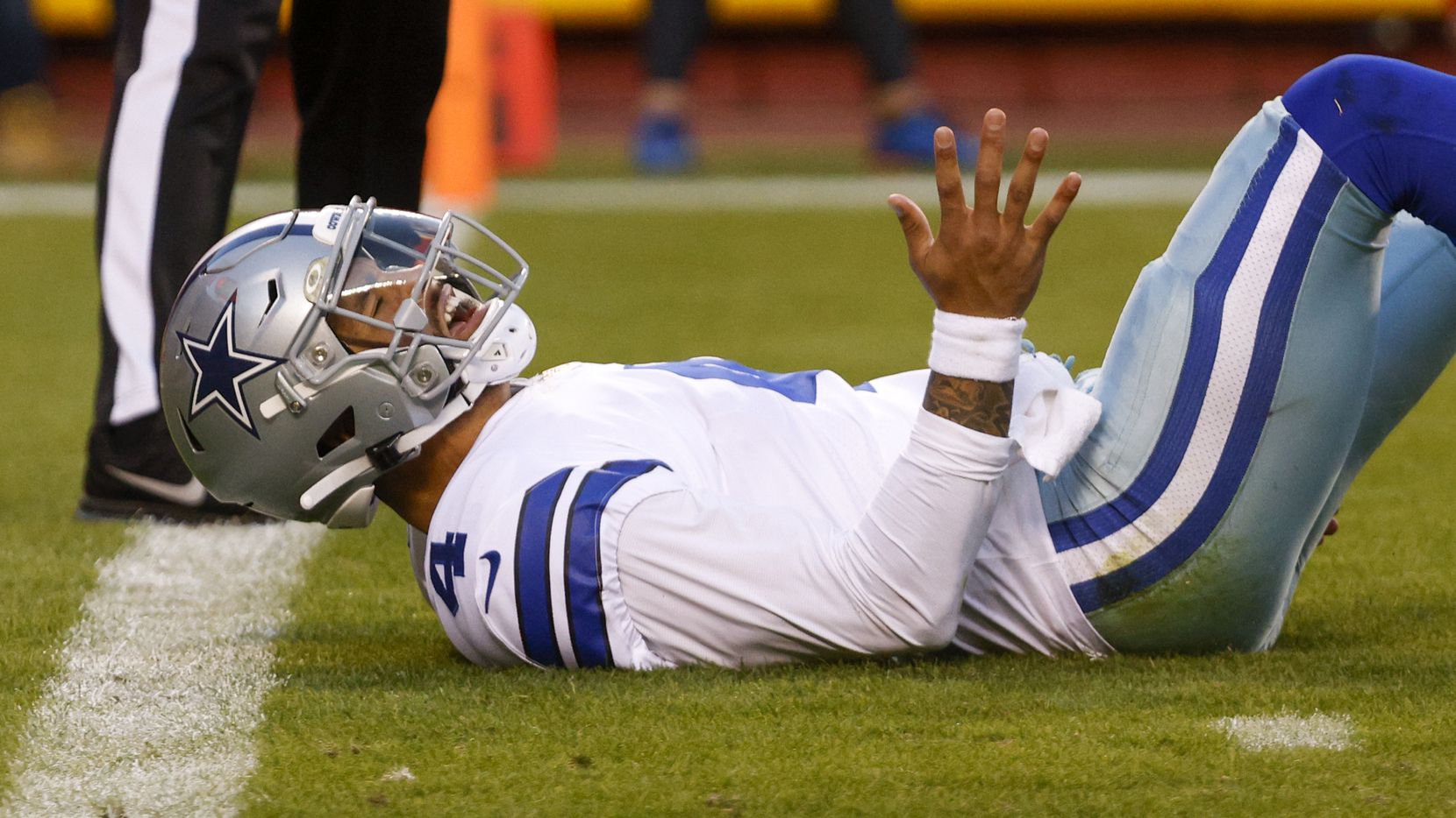 Dallas Cowboys quarterback Dak Prescott (4) reacts after being knocked to the ground by...
