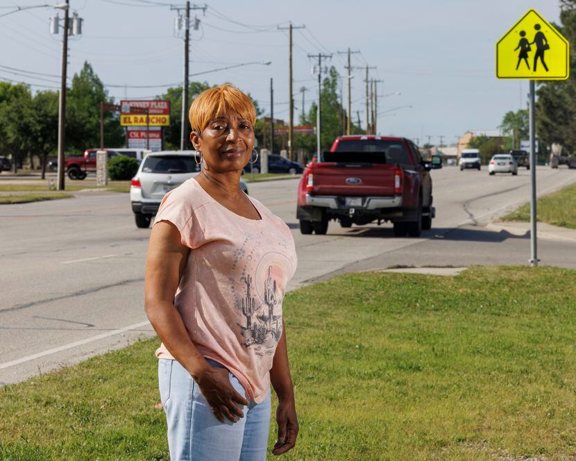Jennifer Hollins stands alongside State Highway 5 near Smith Street in McKinney, Texas,...