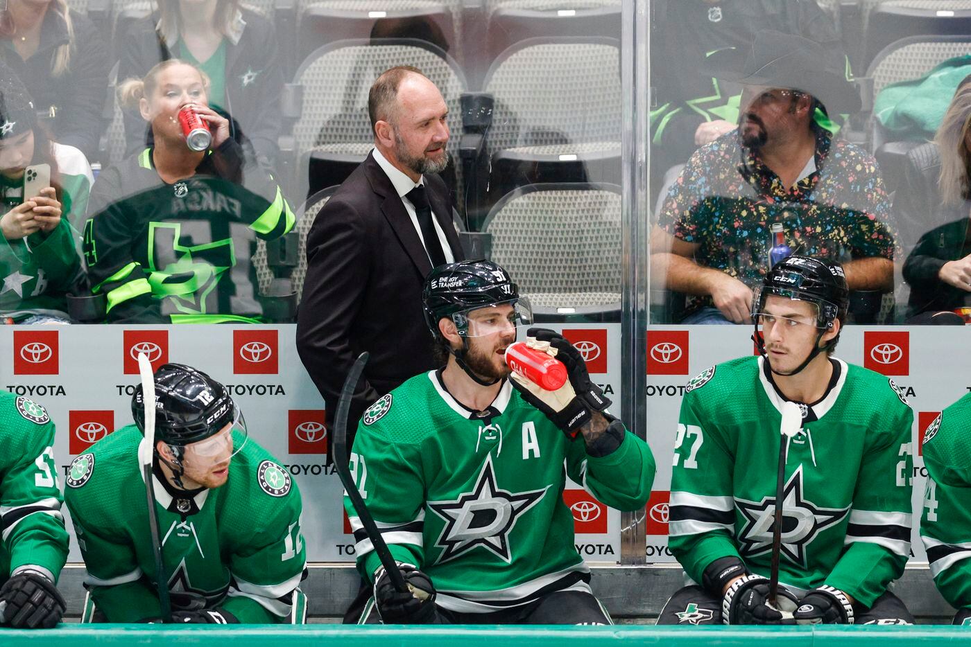 Dallas Stars head coach Peter DeBoer walks the bench during the first period of an NHL game...
