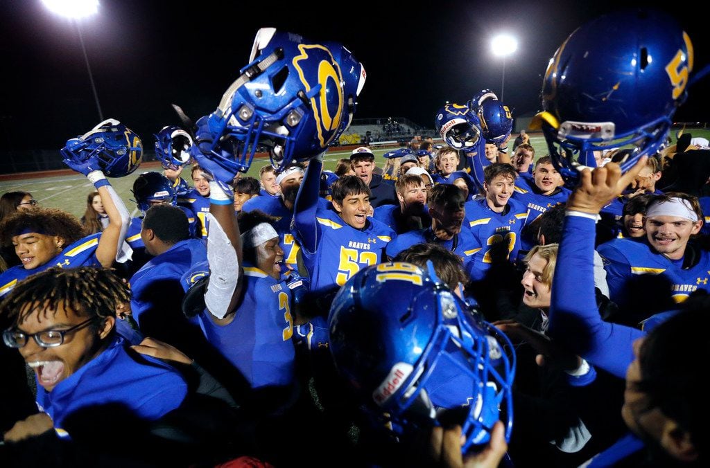 The Community High football team and students celebrate their win over Dallas Roosevelt at...