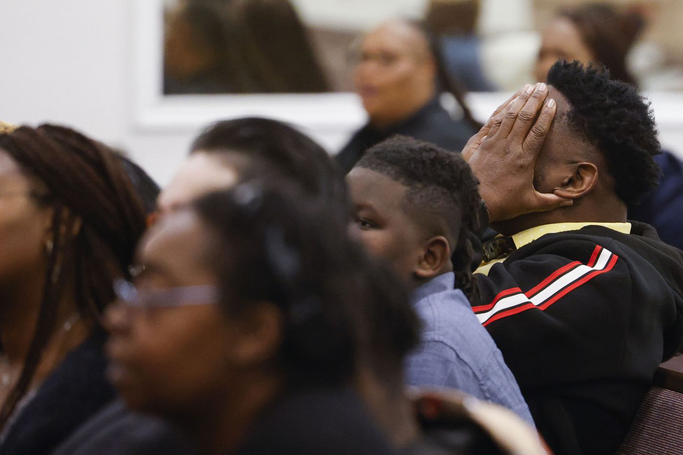 Greg Powell, grandfather of late Legend Chappell, covers his face out of emotion while...