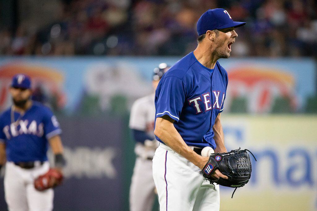 Texas Rangers starting pitcher Cole Hamels reacts after giving up a double to Houston Astros...