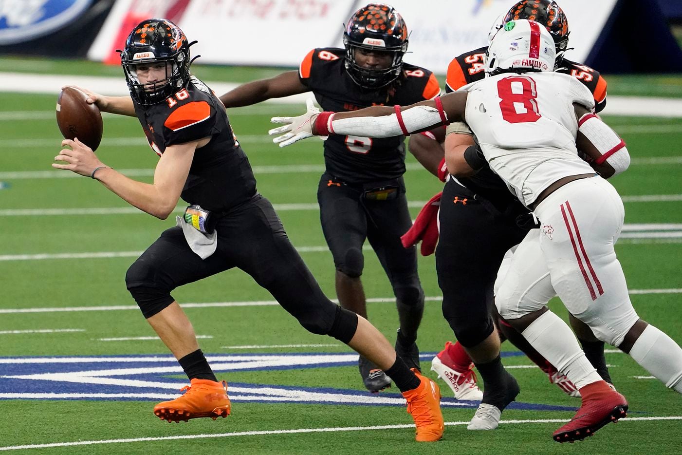Aledo quarterback Brayden Fowler-Nicolosi (16) gets past Crosby defensive lineman Jeremiah Isaac (8) during the first half of the Class 5A Division II state football championship game at AT&T Stadium on Friday, Jan. 15, 2021, in Arlington. (Smiley N. Pool/The Dallas Morning News)