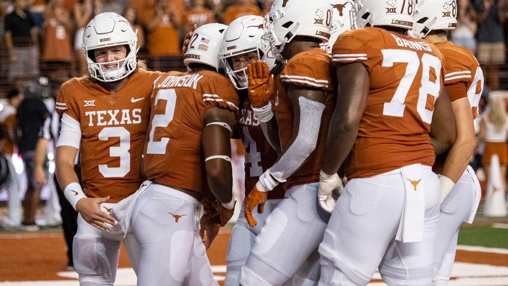 Texas running back Roschon Johnson (2) celebrates with teammates, including Quinn Ewers (2),...