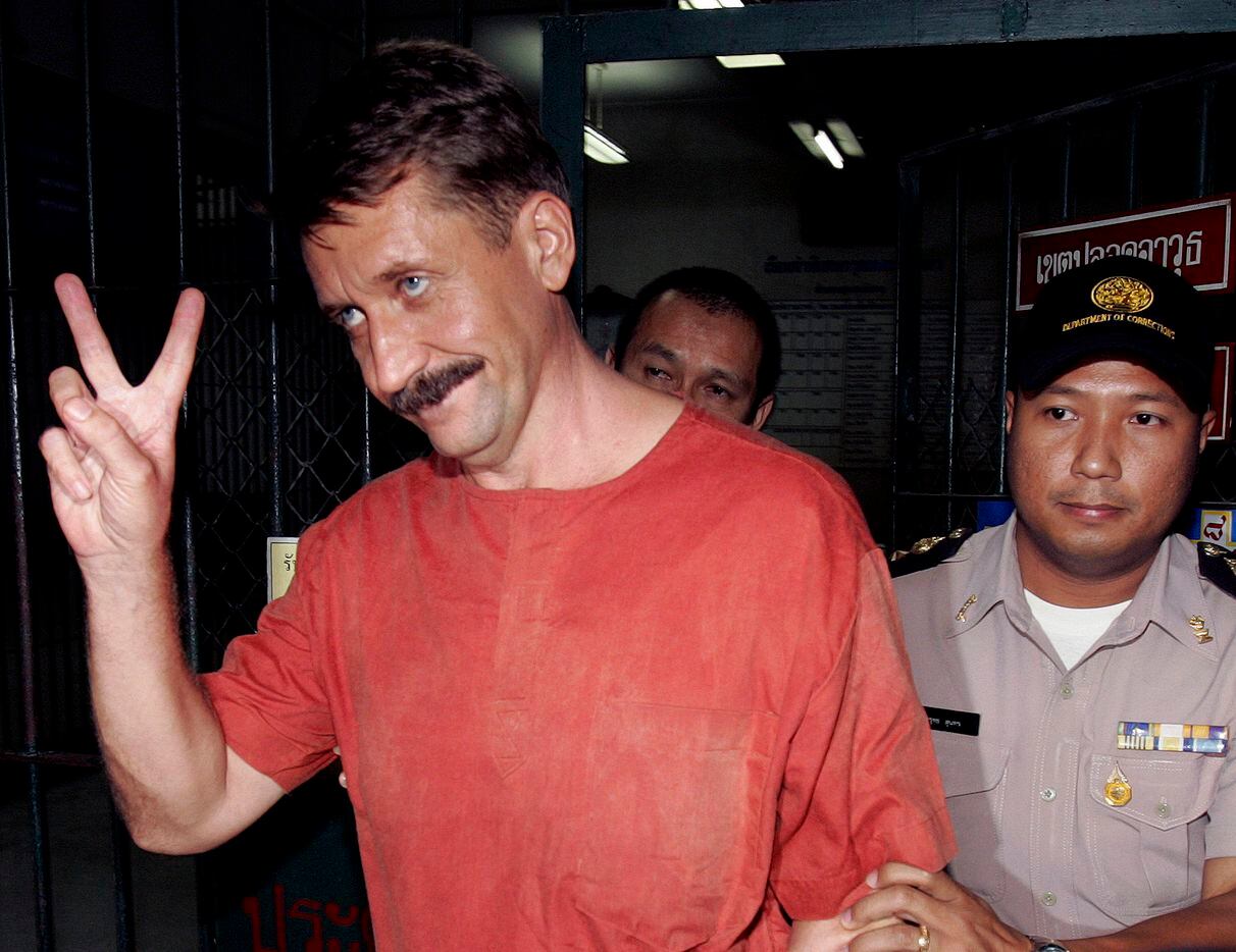 Alleged Russian arms dealer Viktor Bout gestures as he is taken to a van to be transported...