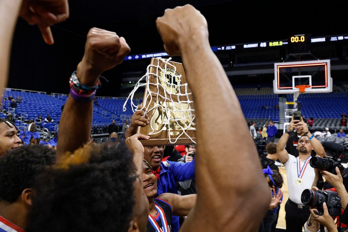 The Duncanville team raises the Class 6A state championship trophy at the Alamodome in San...