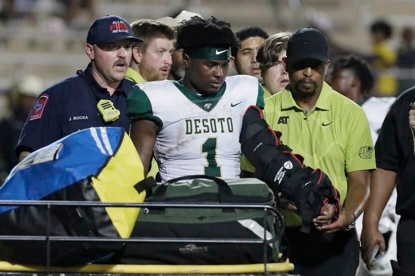 DeSoto running back Deondrae Riden Jr. (1) was carted off of the field with his arm in a...