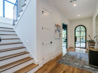 Stairs off a spacious hallway downstairs lead to a spacious game room.