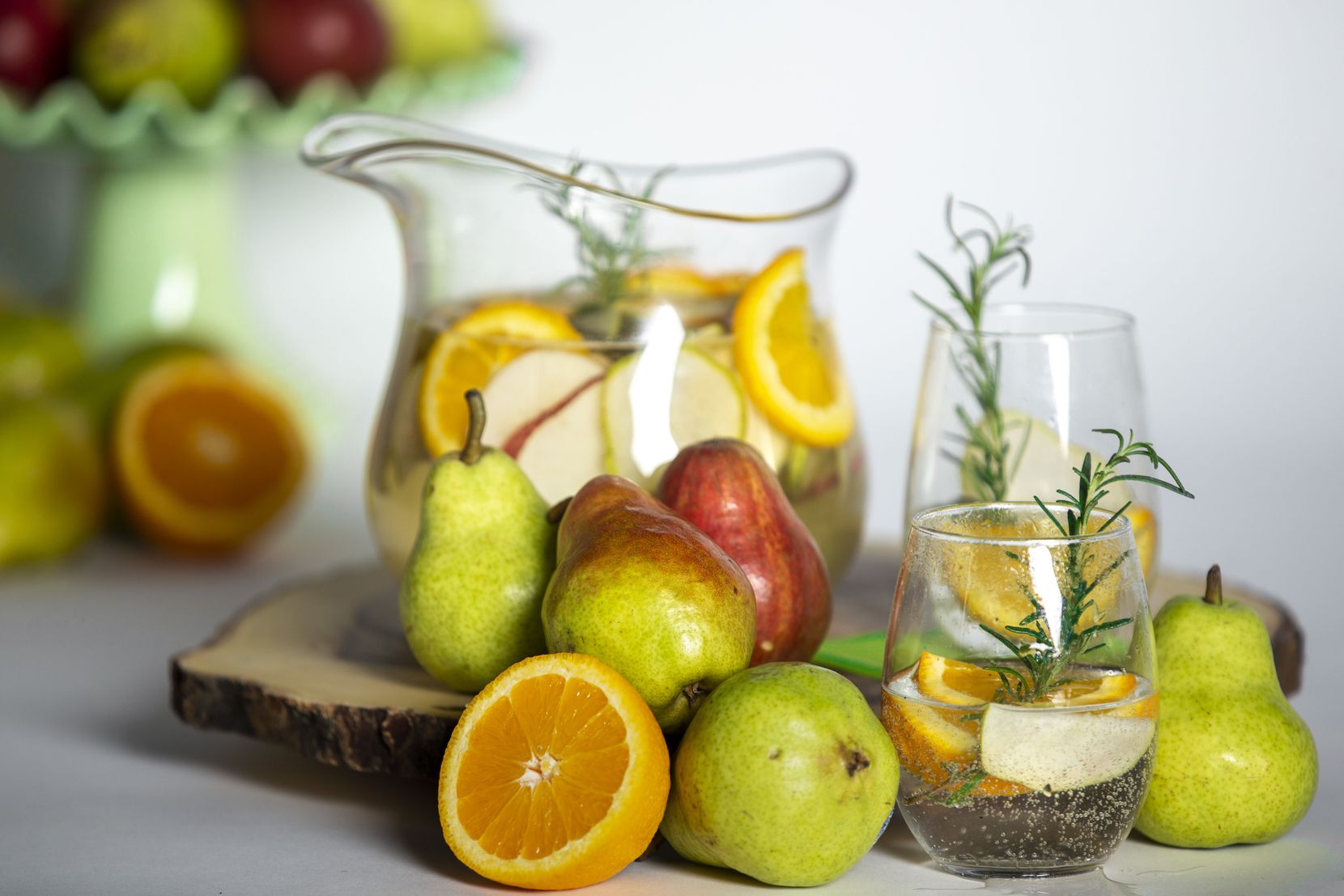 A pitcher of pear and rosemary prosecco sangria