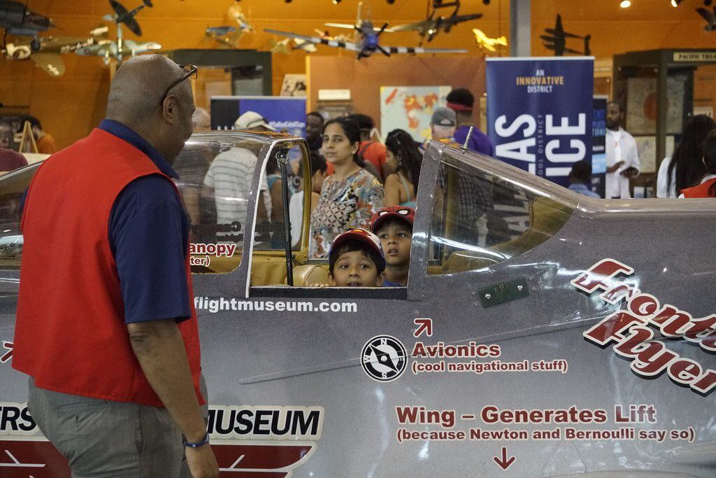 Twins Aditya and Arjun Agrawal check out the cockpit of a plane at the Frontiers of Flight Museum in Dallas.