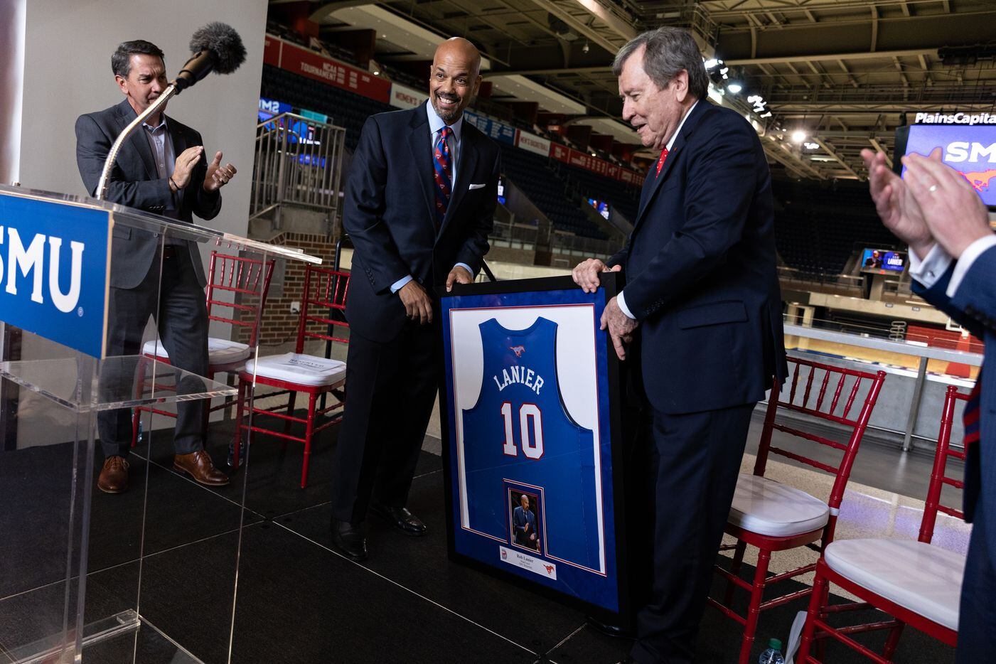 SMU’s new Head Men’s Basketball Coach Rob Lanier holds up his new jersey with SMU President...