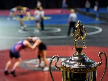 The championship trophy is seen as wrestlers compete during the NCWA national championships...