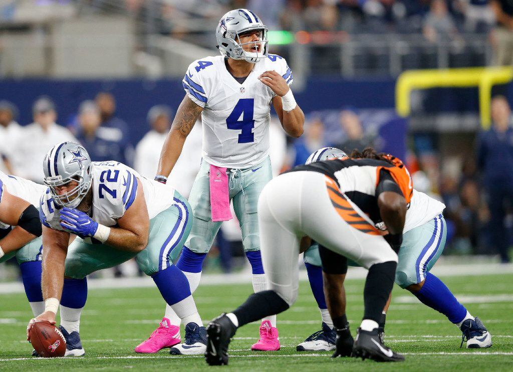 Dallas Cowboys quarterback Dak Prescott (4) communicates to his teammates at the line of...