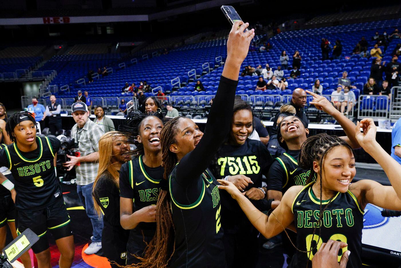 DeSoto guard Ayanna Thompson (20) takes a selfie after winning the Class 6A state...