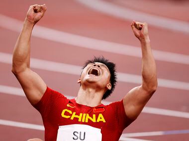 China’s Su Bingtian celebrates his run in the 100 meter semifinal during the postponed 2020...